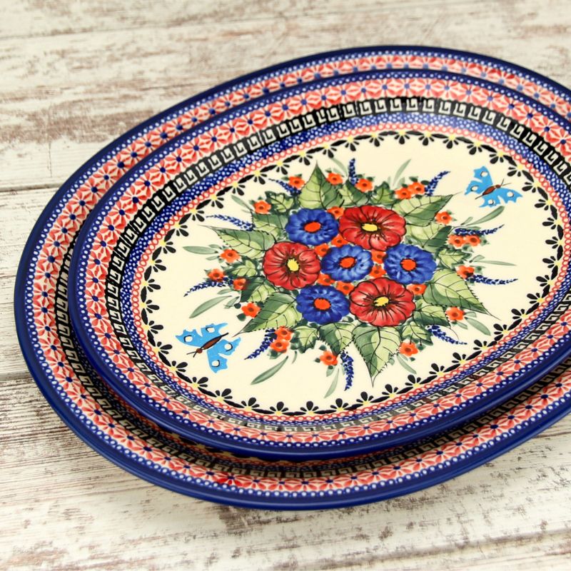 Handmade Polish pottery serving platter and rectangular tray from Boleslawiec on a set table